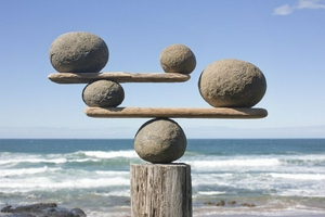 rocks-balancing-on-driftwood--sea-in-background-153081592-591bbc3f5f9b58f4c0b7bb16